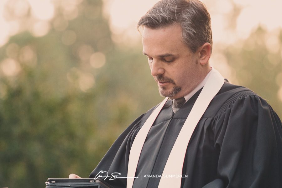 minister praying at lesbian wedding ceremony