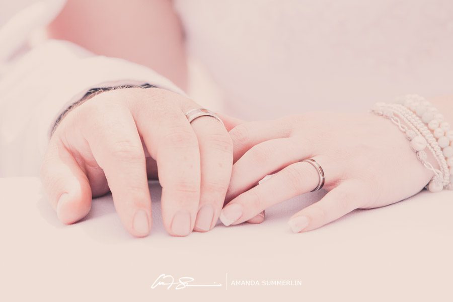 photograph of newlyweds hands with wedding rings