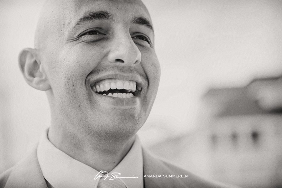 black and white photo of groom laughing