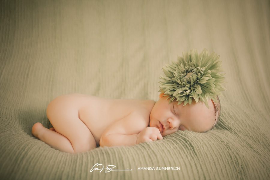 Baby girl with large green flower