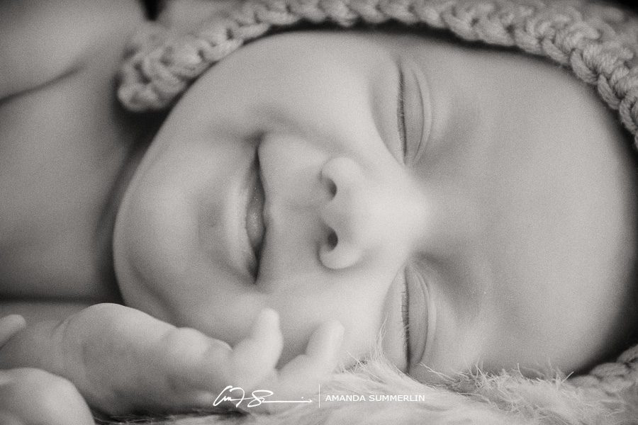 black and white photo of baby smiling