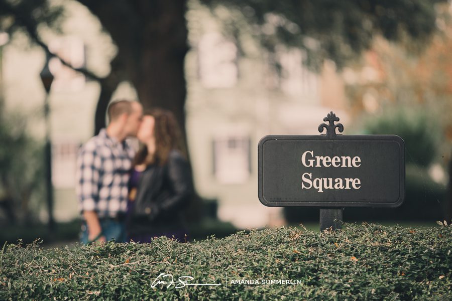 Engaged couple poses in historic Greene Square in downtown Savannah, Georgia