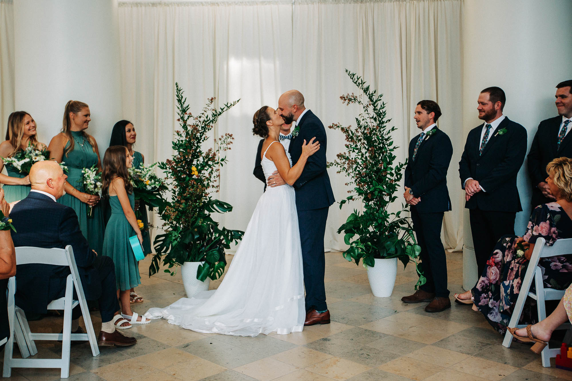 A bride and groom share their first kiss at their wedding ceremony