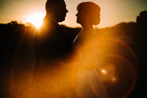 a newlywed heterosexual couple looks at each other at sunset at Glover Park Brewery in Marietta