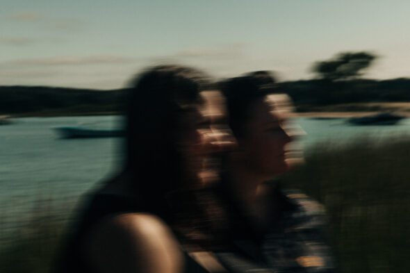 blurry engagement photo at the beach