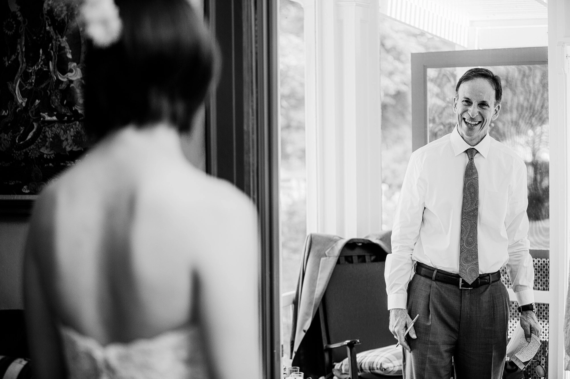 a father sees his daughter in her wedding dress for the first time