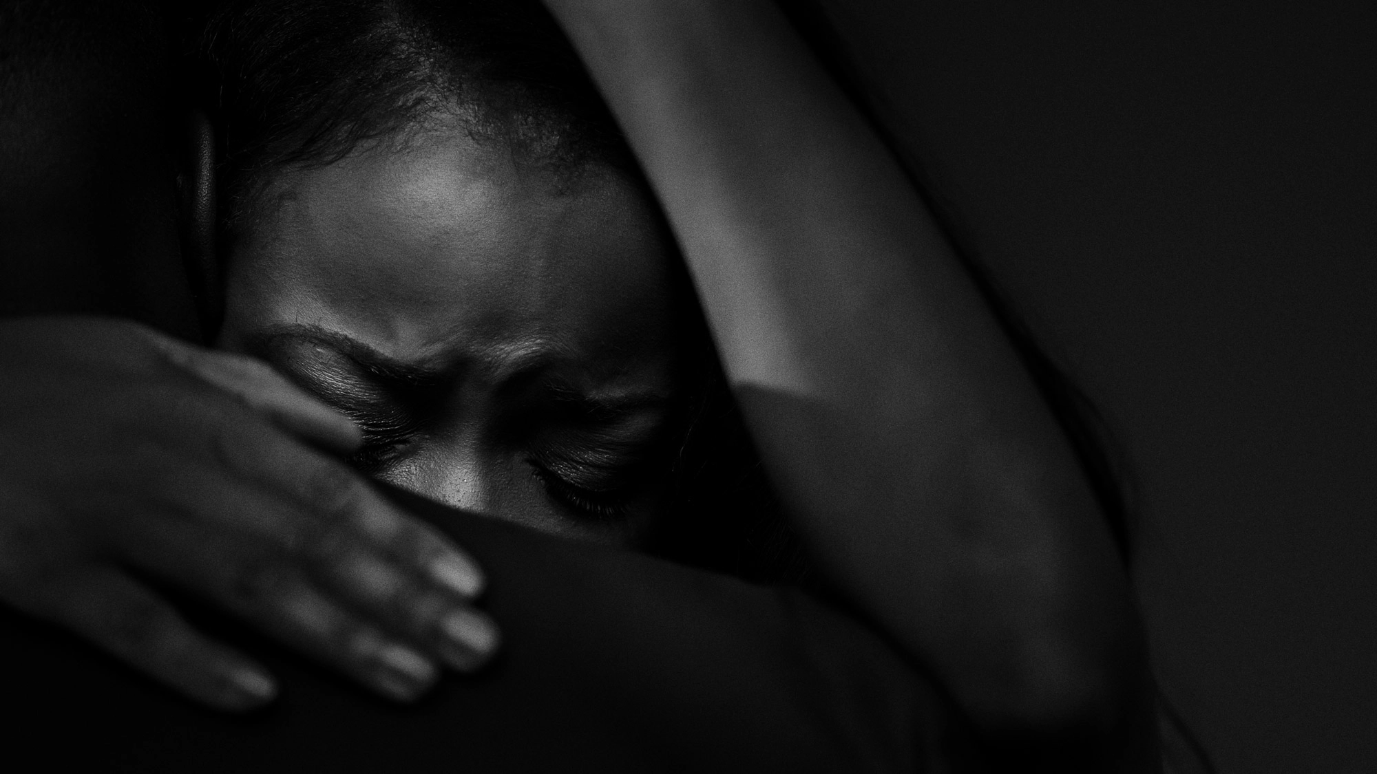 A black bride is emotional during her first dance.