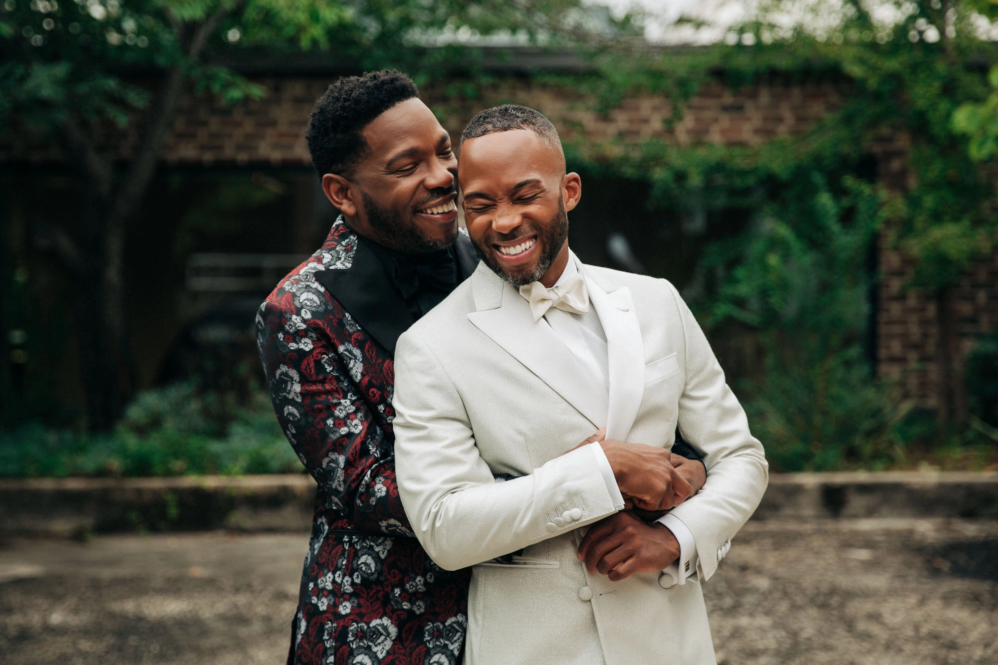 two grooms hug at their wedding at Atlanta contemporary art center