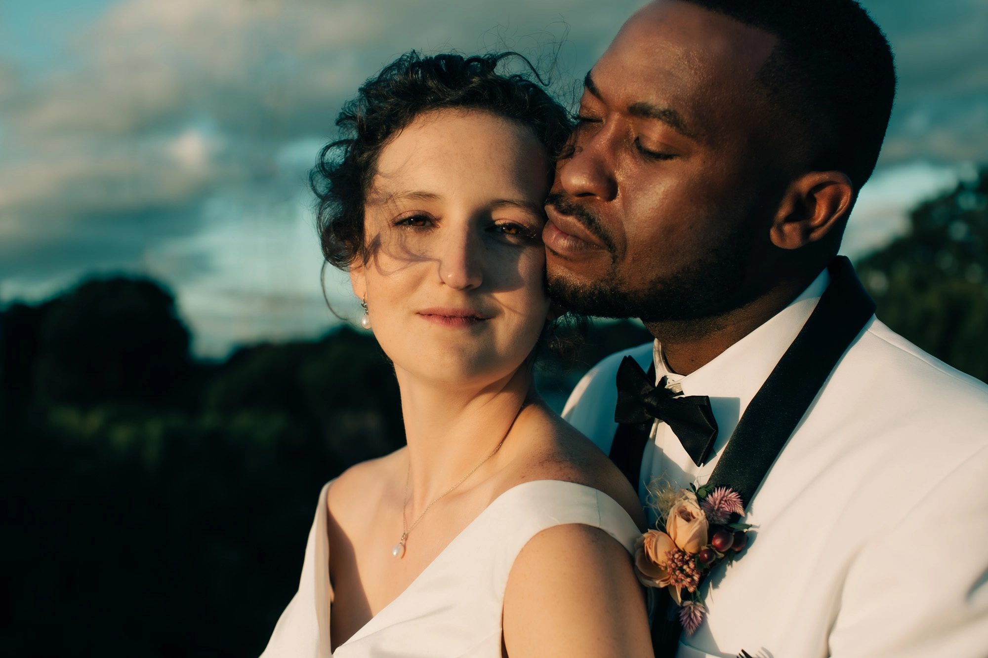 a bride and groom pose at sunset on top of historic Rhodes Hall in Atlanta