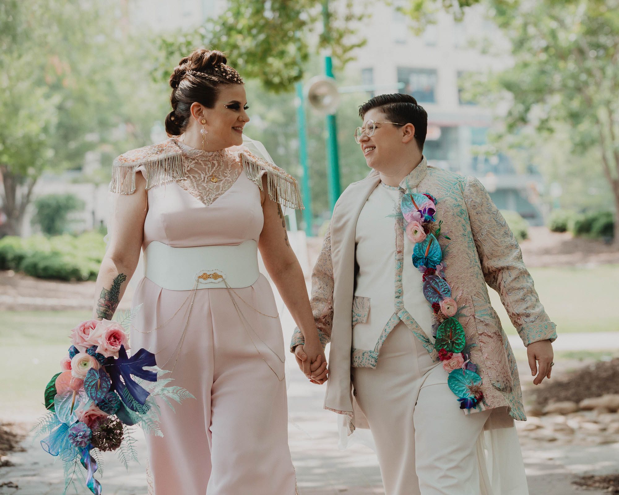 photos of newlywed couple walking in Centennial Park in downtown atlanta