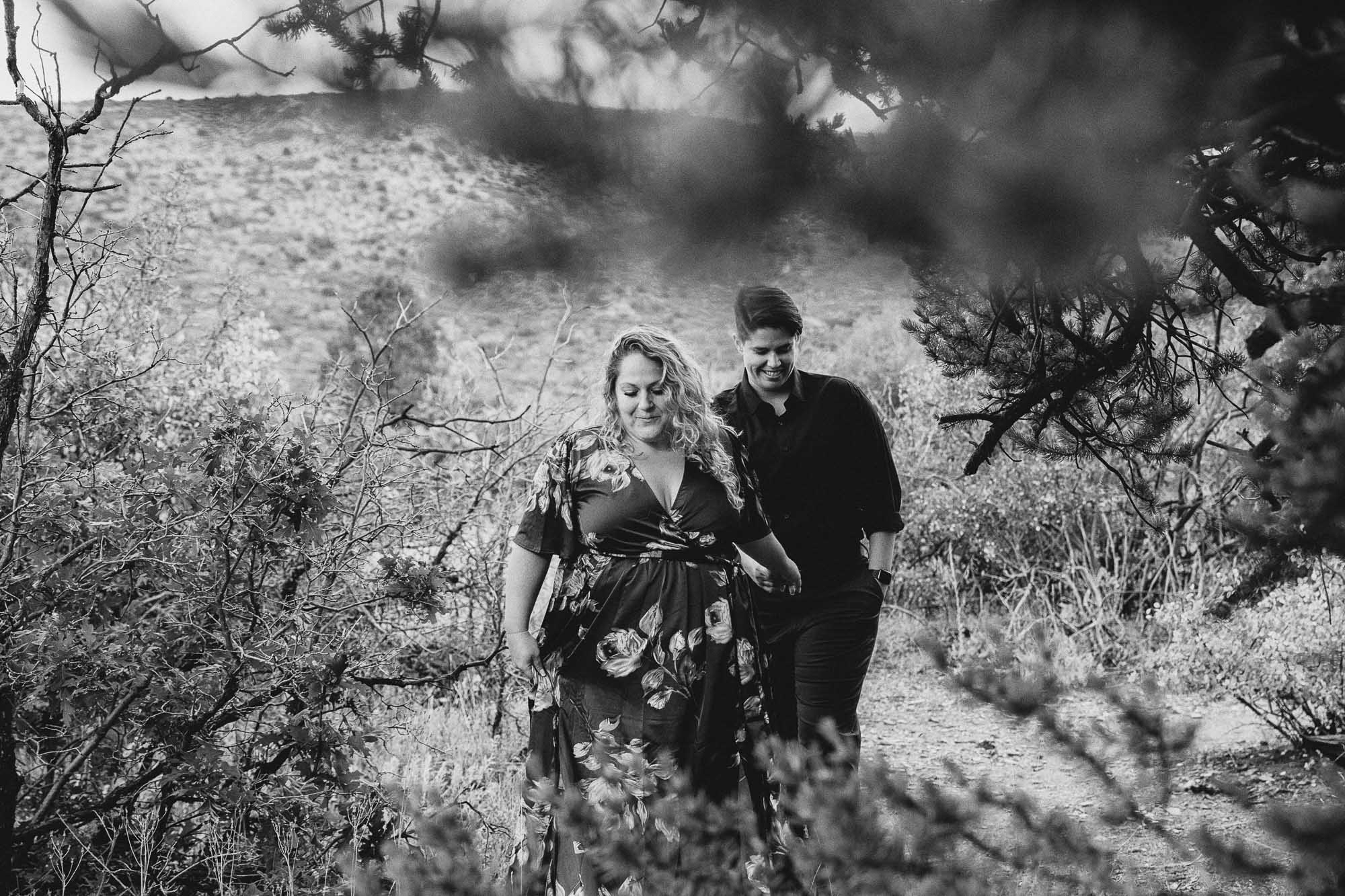 LGBTQ couple walks on a hiking trail during their Colorado adventure engagement photo session