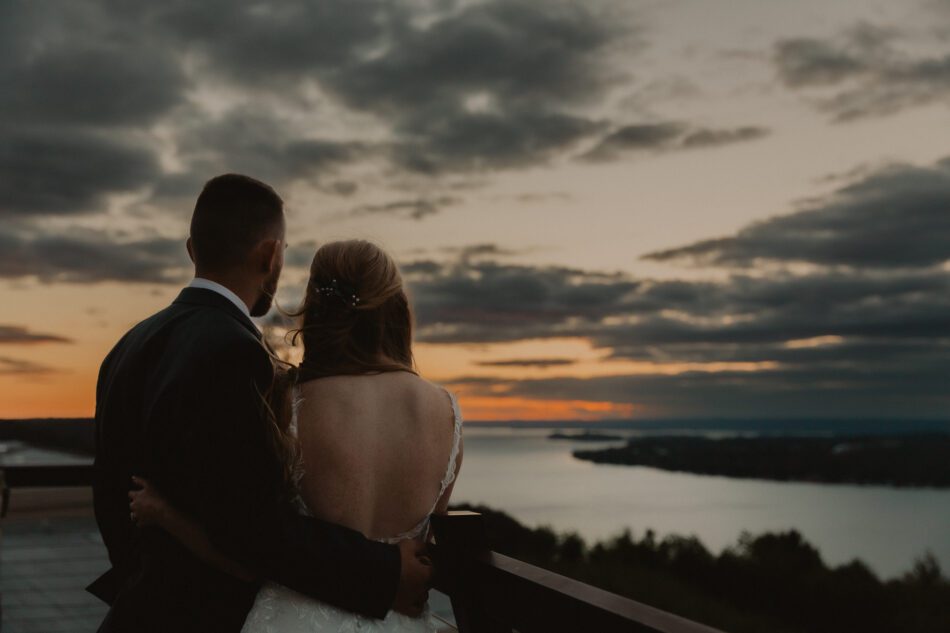 newlywed couple watches the sun set over lake guntersville in Alabama