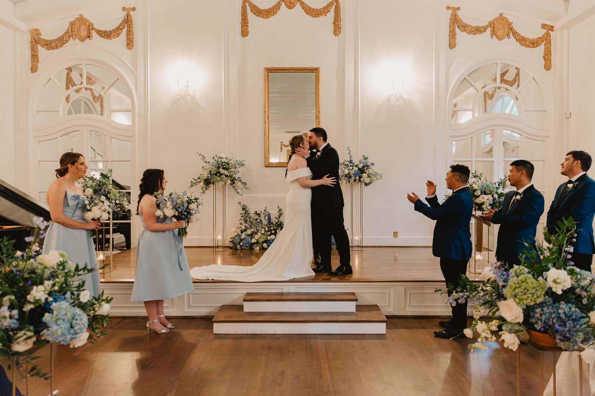 A bride and a groom share their first kiss during their wedding ceremony in the ballroom of historic Atlanta Wimbish house