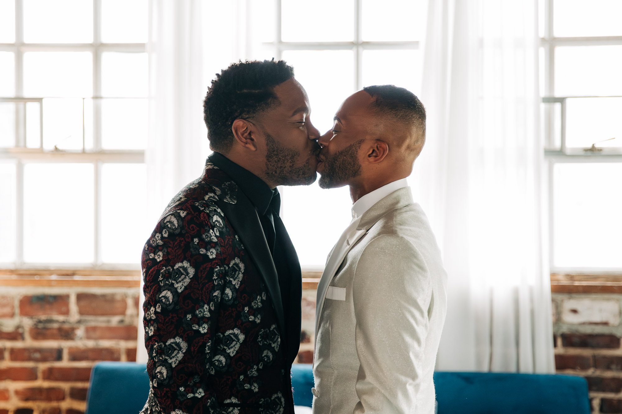 two men share a kiss after seeing each other for the first time on their wedding day at The Atlanta Contemporary, an LGBTQ friendly venue in Atlanta