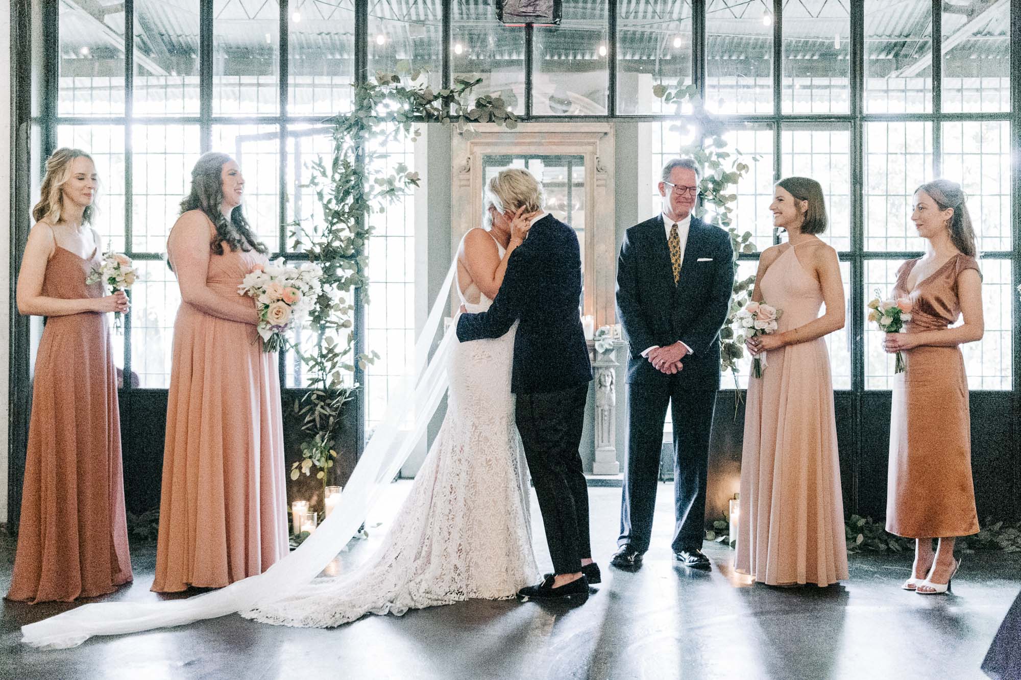 an lgbtq couple has their first kiss at their wedding ceremony at Westside Warehouse, an lgbtq friendly wedding venue in Atlanta