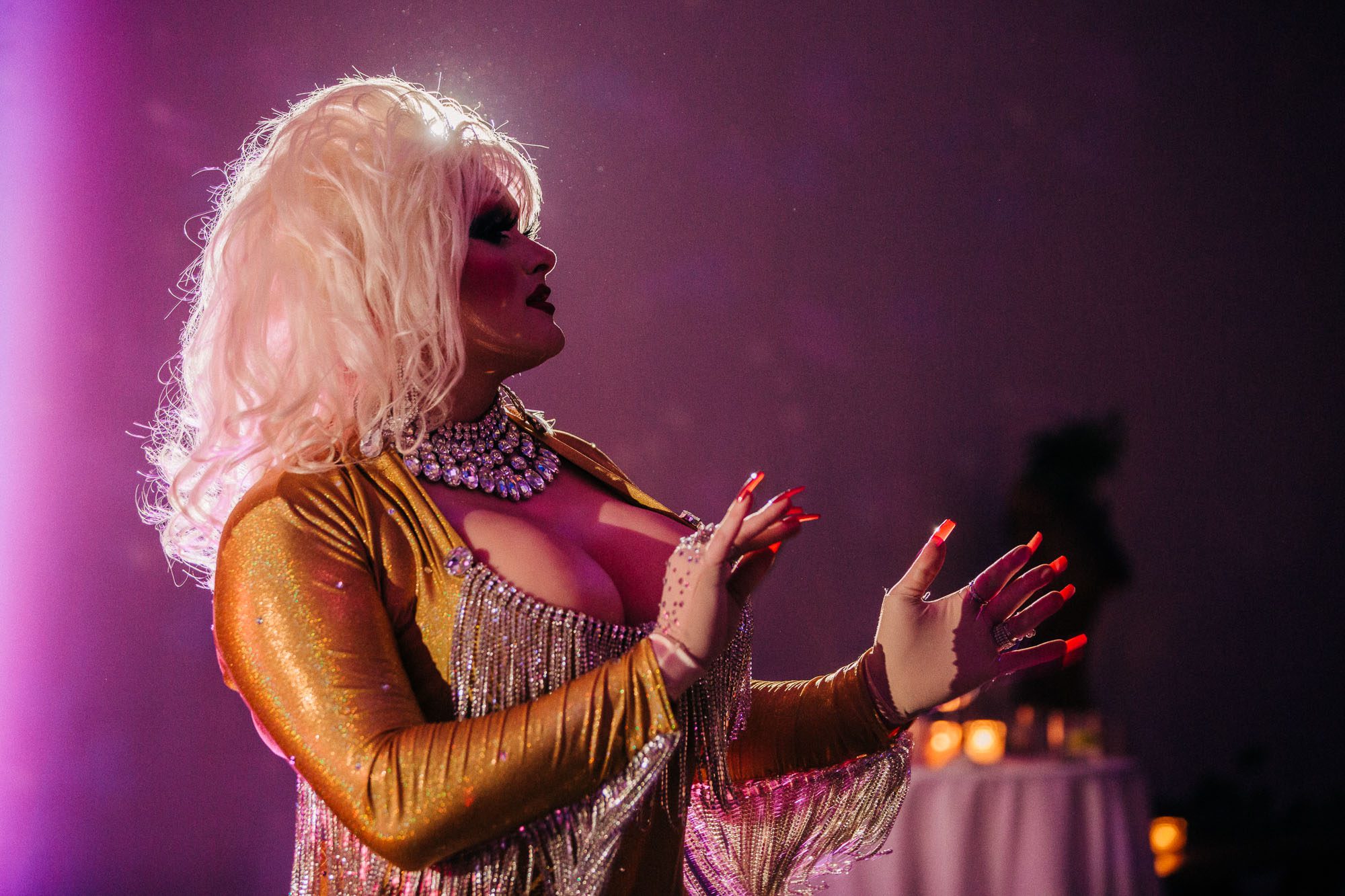 a drag queen dressed as Dolly Parton performs at a wedding reception at Westside Warehouse, an lgbtq friendly wedding venue in Atlanta
