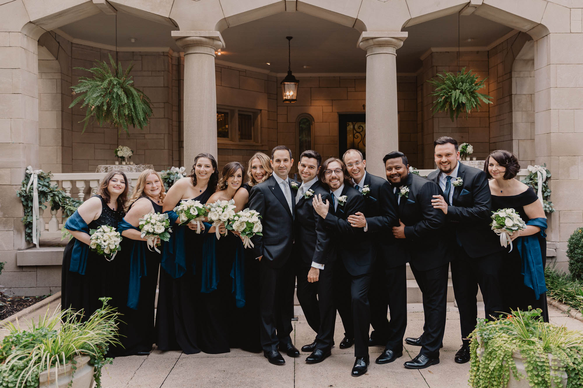 a gay newlywed couple and their wedding party stand in front of LGBTQ friendly Wimbish House in midtown Atlanta, an historic home converted to a wedding and events venue