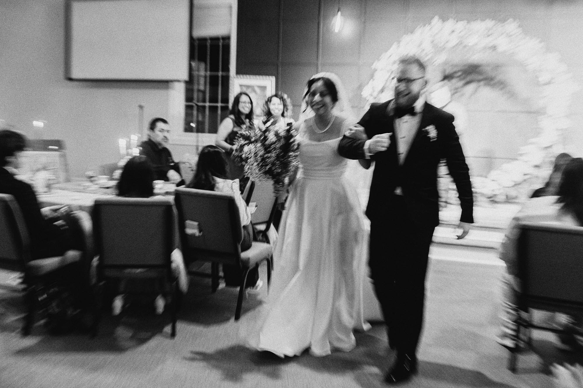 Guests cheer as R and J walk back up the aisle at Vinings Lake Church in Smyrna, Georgia.