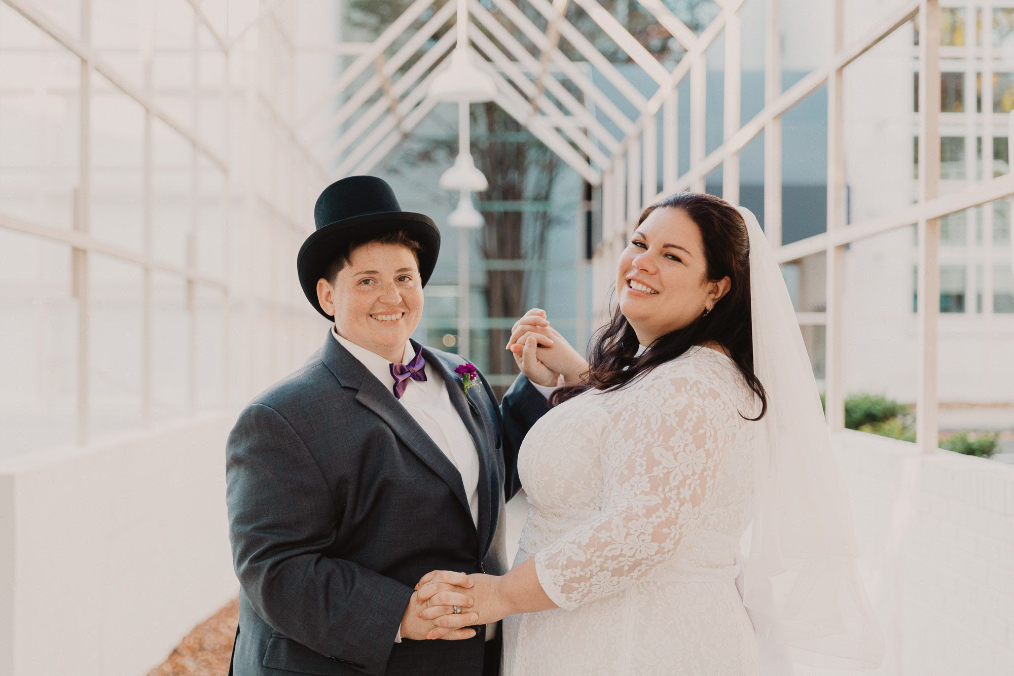 a queer NC couple smiles happily on their wedding day