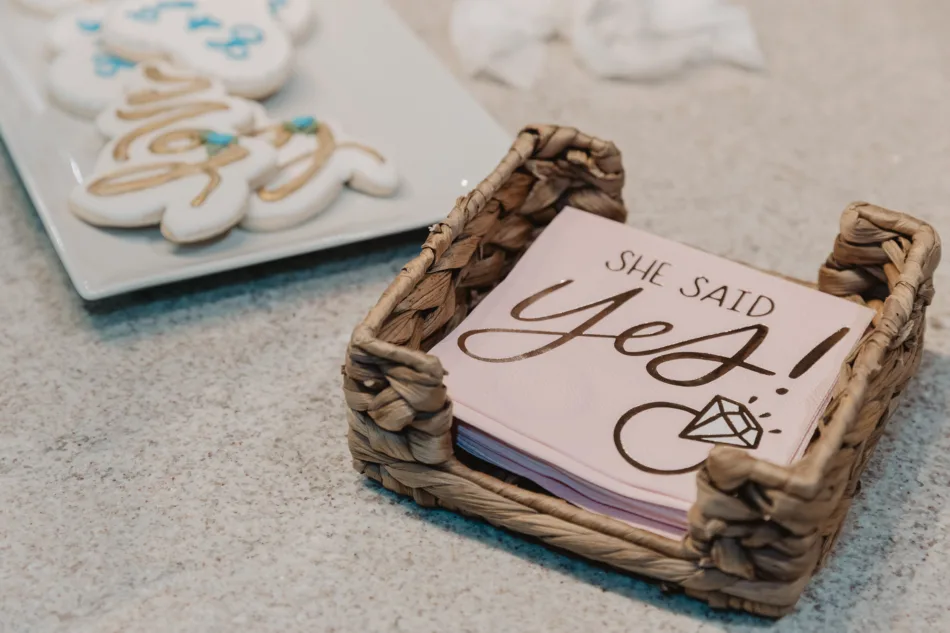 Surprise proposal decorations, pink napkins, that say she said yes