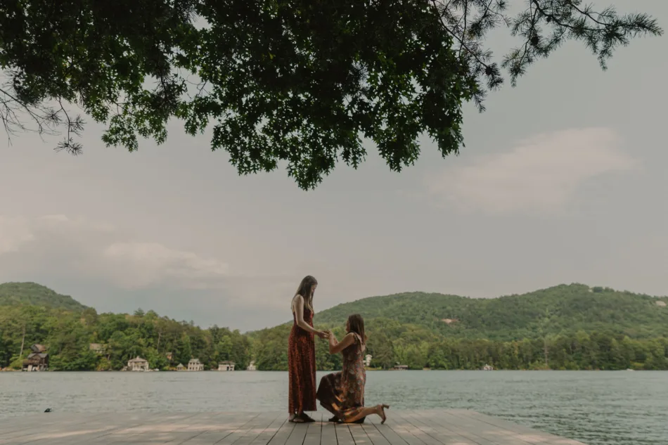 And a woman kneels to propose to her partner, while presenting an engagement ring
