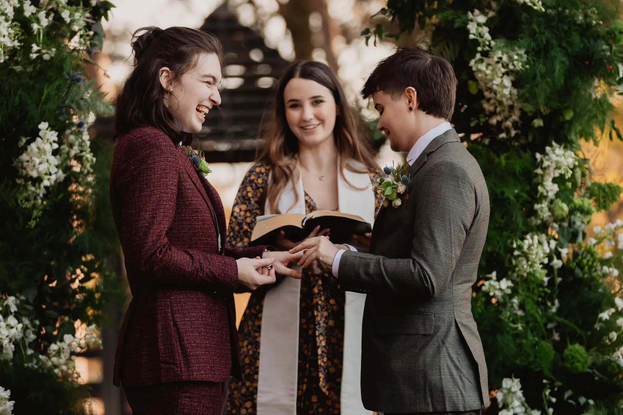 Queer couple exchanging rings during a wedding ceremony at Serenbe, captured by Atlanta wedding photographer Amanda Summerlin